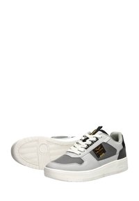 White and gray sneaker with mesh and leather, padded collar, black accents, thick white sole, and prominent brand label on the side.