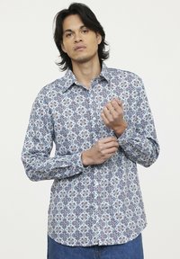 Langärmliges Button-Up-Hemd mit einem blau-weißen Blumenmuster und roten Akzenten. Hergestellt aus einem leichten, gewebten Stoff.