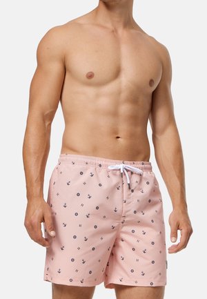 Roze zwemshorts gemaakt van lichtgewicht stof, met een patroon van ankers en windrozen, en een witte trekkoord in de taille.