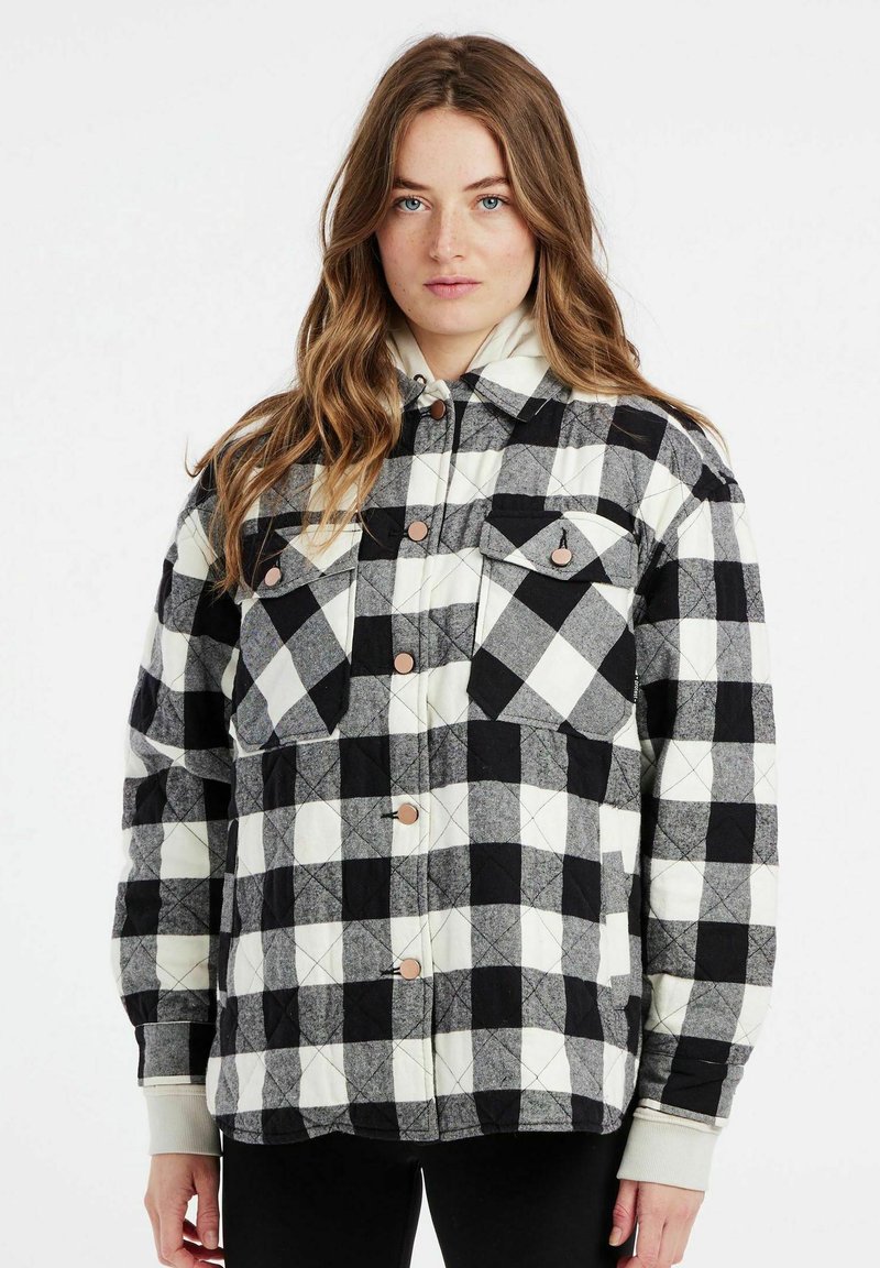 Gequilted pluchen jas in zwart en wit, met twee borstzakken, drukknoopsluiting en een relaxte pasvorm. Zachte stof met een geruit patroon.