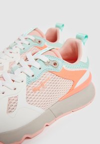 White and pastel sneakers with mesh panels, pink and mint accents, textured surfaces, and white laces. Features a branding detail on the side.