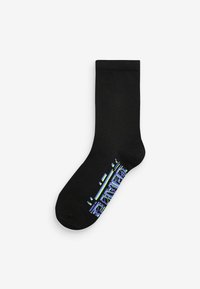 Chaussette noire avec une texture lisse, ornée d'un design graphique coloré à la cheville dans des nuances de bleu et de vert.