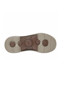 Semelle de chaussure en caoutchouc beige, avec un centre texturé marron clair et des détails circulaires. Comprend des sections de grip à motifs et des accents surélevés.
