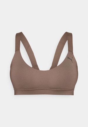 Brun idretts-BH med glatt tekstur, brede stropper og scoop-hals. Har en liten svart logo på siden.