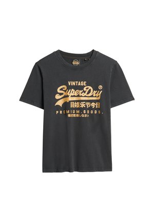 Sort bomulds T-shirt med korte ærmer, med guldtekst "VINTAGE SuperDry" og andre trykte detaljer. Rund halsudskæring, afslappet pasform.