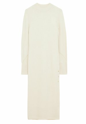 Robe pull longue couleur crème avec manches longues, poignets et ourlet côtelés, et petits boutons sur l'ourlet côté.