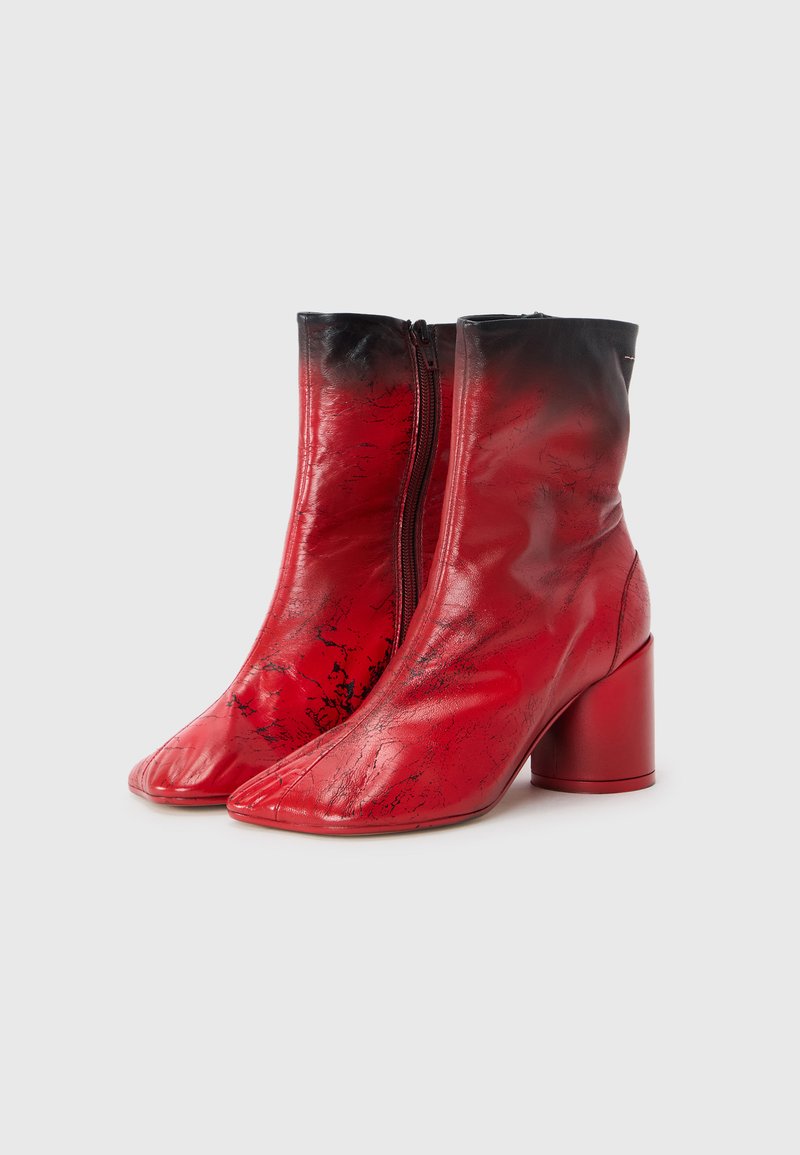 Red leather ankle boots with a glossy finish, featuring a black gradient at the top, pointed toe shape, and a cylindrical heel.