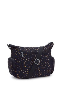 Bolsa de tela negra con patrón de estrellas doradas, correa ajustable, compartimentos con cremallera y bolsillos laterales. Textura suave, diseño funcional.