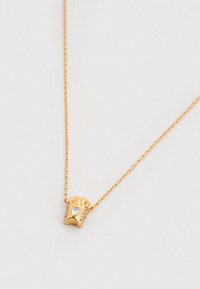 Náhrdelník v zlatom tóne so zaveseným príveskom v tvare rukavice s akcentom v tvare srdca a malými priehľadnými drahokamami, visieť na jemnom retiazke.