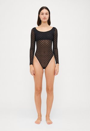 Schwarzer langärmeliger Body aus durchsichtiger Netzware mit dezentem Musterdesign. Rundhalsausschnitt und hoch geschnittene Beine betonen die Silhouette.