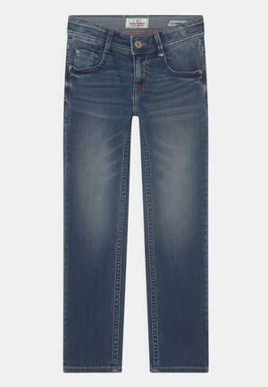 Jean en denim bleu délavé avec poches avant, fermeture par boutons, passants de ceinture et légers détails d'usure au niveau de la partie supérieure de la cuisse.