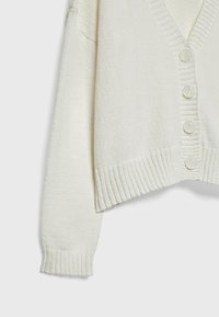 Cream-colored cardigan with a V-neck, five front buttons, ribbed cuffs, and hem. Made of textured knit fabric.
