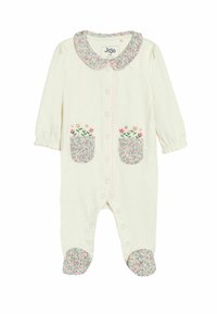 Bebičasti onesie boje kreme s cvjetnim džepovima i čarapicama, s ovratnikom i ružičastim obrubom duž prednje strane.