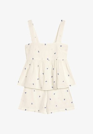 White two-piece outfit featuring a sleeveless top with a peplum cut and blue floral embroidery, paired with matching shorts.