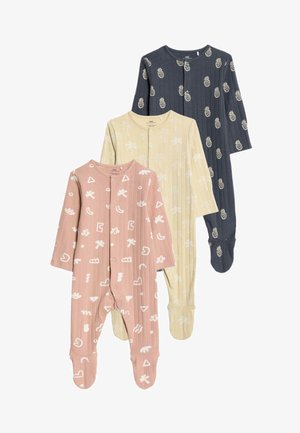 Tres mamelucos para niños con pies: rosa con patrones abstractos blancos, amarillo claro con diseños blancos y azul marino con piñas blancas.