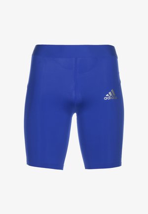 Shorts de sport bleus en matériau extensible avec une texture unie. Présentent le logo doré d'Adidas sur la jambe gauche. Longueur mi-cuisse.