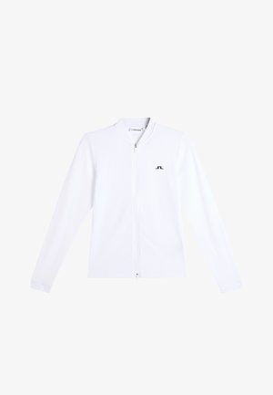 Veste blanche à manches longues avec fermeture éclair, petit logo noir sur le côté gauche de la poitrine et col montant.