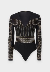 Svart bodysuit med lange ermer, med en dyp V-hals og gullnagledekorasjoner i et linært mønster over brystet og sidene.