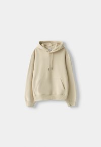 Beige huva sweatshirt med framfickor och snören, uppvisad på en vit bakgrund.