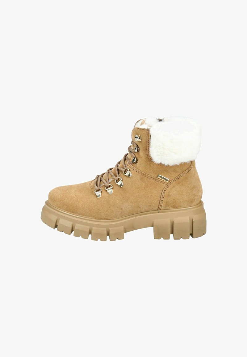 Tan suède enkellaars met een zachte witte bontkraag, metalen oogjes en een stevige beige rubberen zool, voorzien van een vetersluiting.