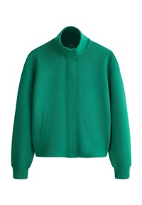 Veste verte à col montant, manches longues, poches avant et fermeture à boutons-pression dissimulée.