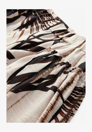Patterned fabric featuring black and brown leaf designs on a light beige background; ruching detail at the waist adds texture.