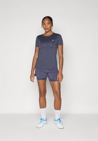 Marineblauw sport t-shirt en shorts van een zachte, lichte stof; voorzien van een klein logo op de borst en een ontspannen pasvorm.