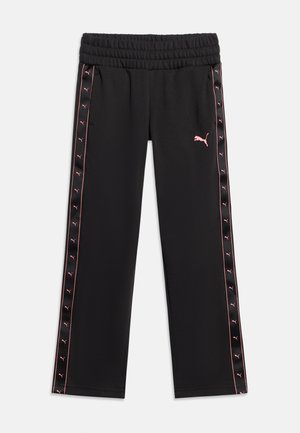 Mustad elastse vöökohaga püksid roosade Puma logodega külgtriipudel ja roosa Puma kassist logo vasakul reiel.