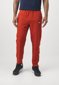 Nike Performance Jogginghose - dragon red/life lime/white