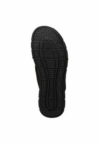 Suola di scarpa in gomma nera con superficie tessurizzata, caratterizzata da modelli circolari e rettangolari per una migliore aderenza e scanalature contornate per la flessibilità.