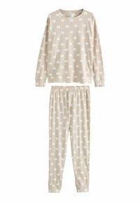 Beige pyjamastel met een lange mouwen-top en een elastische taillebroek, beide met kleine witte pompoenpatronen. Zacht katoenen materiaal.