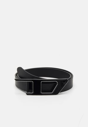 Black leather belt rolled up with a glossy black metal buckle featuring geometric cutout shapes.