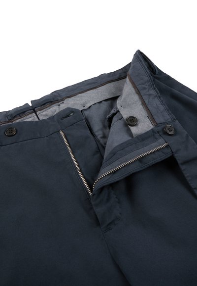 Dark navy trousers with open zipper, button fasteners, and visible gray inner lining on a white background.