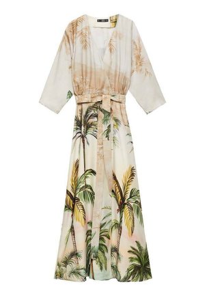 Long, wrap-style dress featuring a light fabric with palm tree prints in green and brown on a cream background. Includes a tie belt.