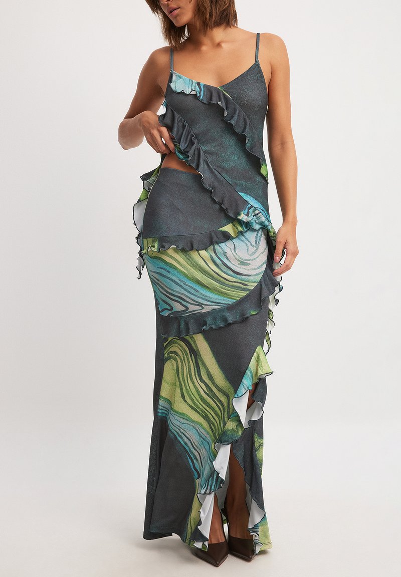 Maxi dress with spaghetti straps, featuring a marbled pattern in green, blue, and gray, layered ruffles, and a side cutout.