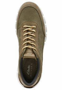 Green suede athletic shoe with beige laces, perforated upper, and white rubber sole. Features "Clarks Nature X" branding on tongue.