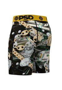 Calzoncillos ajustados con una cinturilla amarilla que presenta un estampado de dinero y joyas, incluyendo billetes de dólar, diamantes y un diseño de cadena de oro.