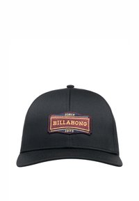 Casquette noire avec un design structuré, arborant un patch brodé multicolore incluant les détails "BILLABONG" et "1973".