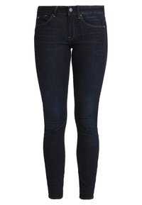 Sötétkék farmer skinny farmernadrág klasszikus öt zsebes kialakítással, övbújtatókkal és gombos záródással. Simaszerkezet, látható minták nélkül.