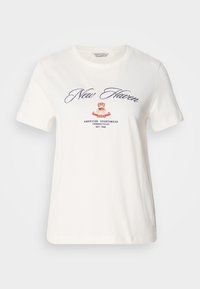 White cotton t-shirt with short sleeves, featuring navy cursive text "New Haven" and a red crown logo, with "GANT" and additional text below.