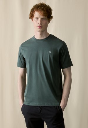 Dark green cotton t-shirt with a crew neck, short sleeves, and a small white logo on the left chest. Smooth texture, relaxed fit.