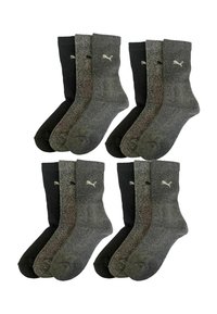 Vier Paar Socken mit einem gerippten Design, zwei in Dunkelgrau, zwei in Schwarz, mit einem dezenten Logo-Akzent in Weiß.