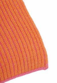 Ribbed knit blanket in vibrant orange with pink accents. Features a textured, soft finish with alternating colored stripes.