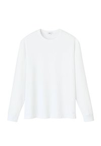 T-shirt en coton blanc à manches longues avec un col rond, coupe décontractée et texture douce. Les poignets présentent un design simple sans ornements.