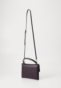 Purple leather crossbody bag with a detachable shoulder strap and top handle. Smooth texture with gold-tone hardware accents. Rectangular shape.