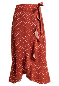 Gonna avvolgente rossa a pois con orlo arricciato e dettaglio a fiocco in vita. Realizzata in tessuto leggero dalla texture morbida.