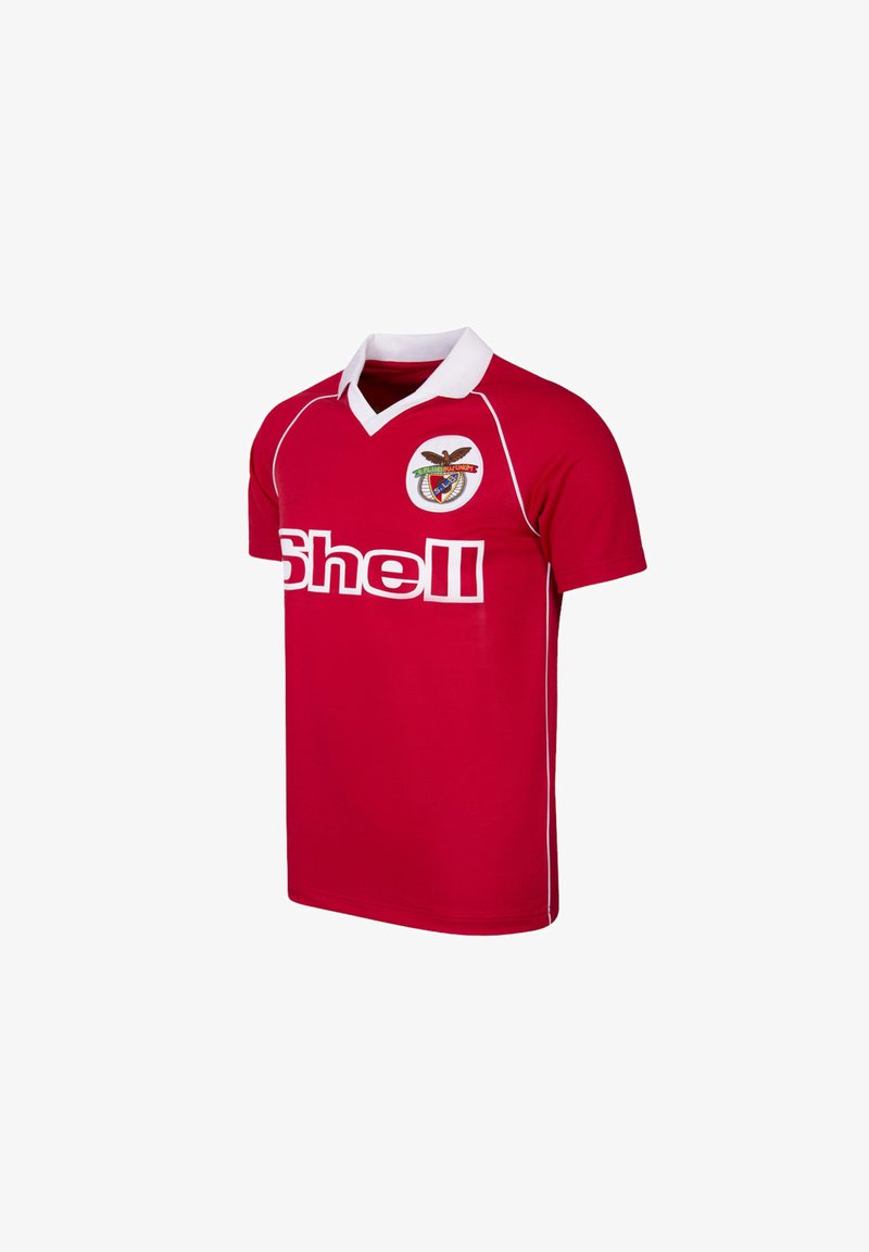 Red short-sleeve soccer jersey with white collar, white piping, Shell sponsor logo, and a circular team crest with an eagle on the chest.