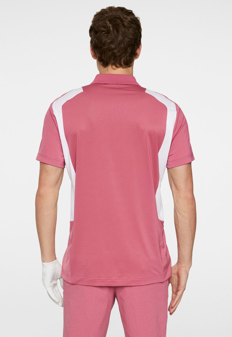Kortärmad pikétröja i rosa med vita sidopaneler; tillverkad av smidigt, lätt material; har en klassisk krage och en slank passform.