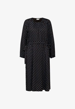 Musta mekko sinisillä pilkuilla, pitkät hihat, pyöreä kaula-aukko, rypytetty vartalo, vyötärölle solmittava nauha, valuva kangas, polveen ulottuva siluetti.