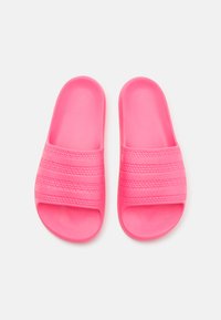 Pink rubber slides with three textured horizontal bands, open-toe design, smooth surface, and rounded edges. Lightweight and casual.